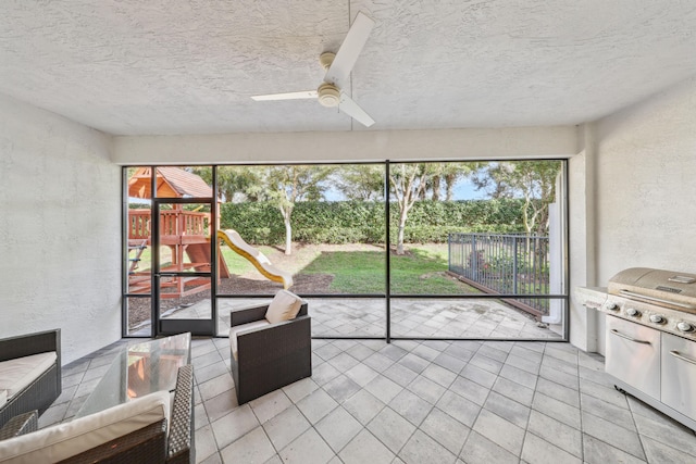 sunroom featuring ceiling fan