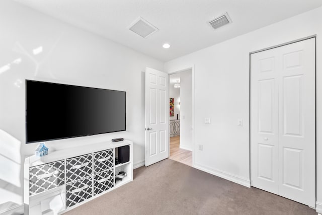 carpeted bedroom with a closet