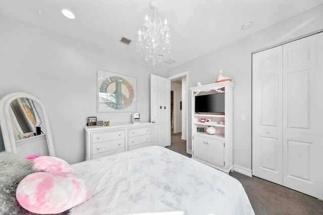 carpeted bedroom featuring a closet and an inviting chandelier