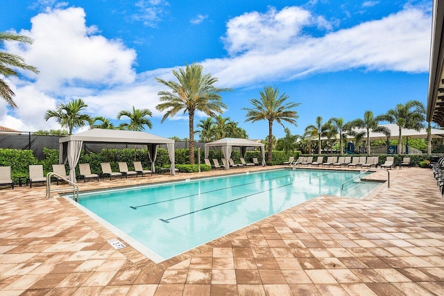 view of swimming pool featuring a patio area and a gazebo