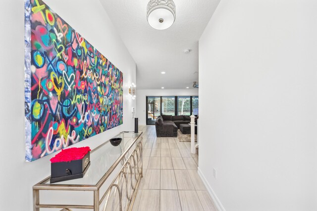 tiled living room featuring ceiling fan, a textured ceiling, and built in features