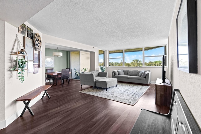 living room with dark hardwood / wood-style floors, a chandelier, and a textured ceiling