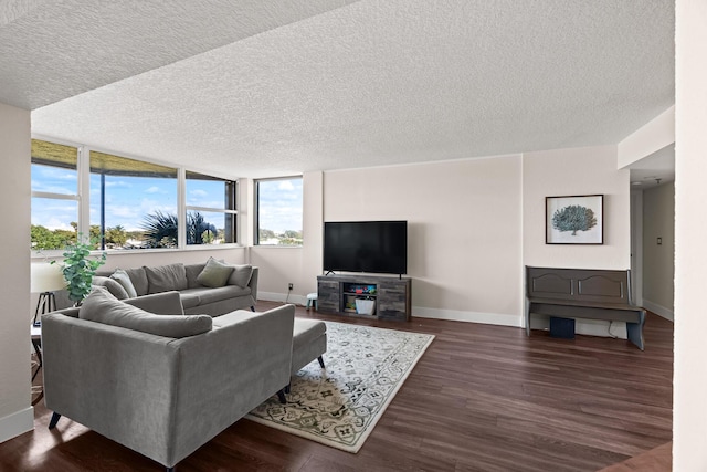 living room featuring dark wood-type flooring and a textured ceiling