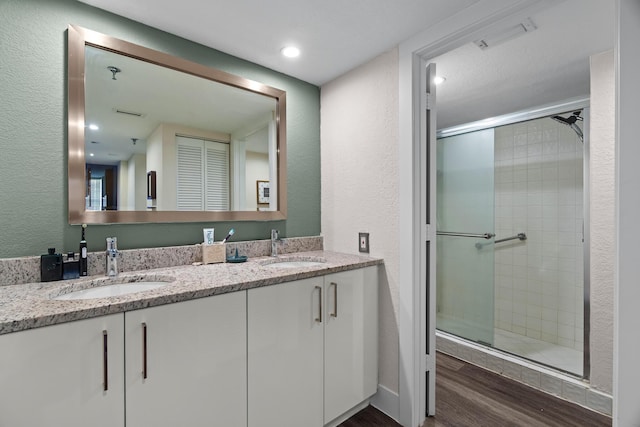 bathroom with vanity, hardwood / wood-style floors, and an enclosed shower