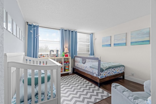 bedroom featuring a textured ceiling and hardwood / wood-style floors