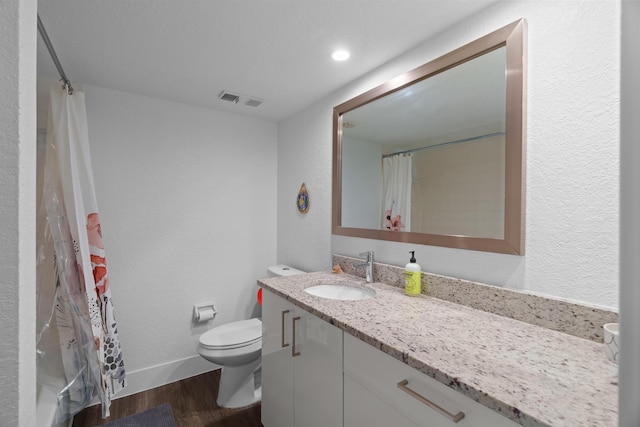 bathroom with toilet, vanity, wood-type flooring, and a shower with curtain