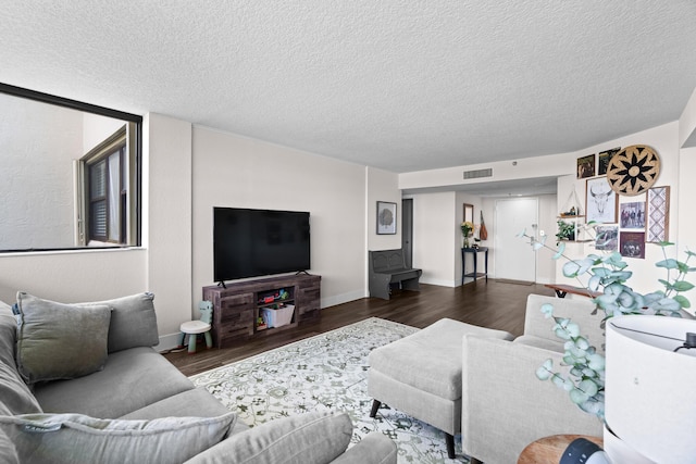 living room featuring a textured ceiling and dark hardwood / wood-style flooring