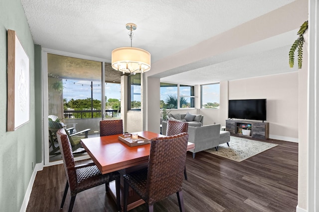 dining area featuring a textured ceiling, dark wood-type flooring, a chandelier, and floor to ceiling windows