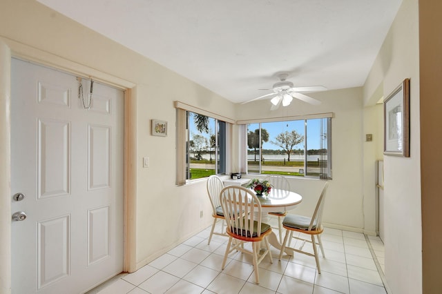 tiled dining area with ceiling fan