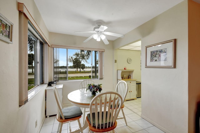 dining space with ceiling fan and light tile patterned floors