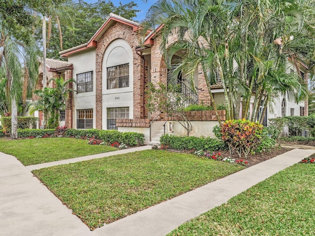 mediterranean / spanish house featuring a front lawn