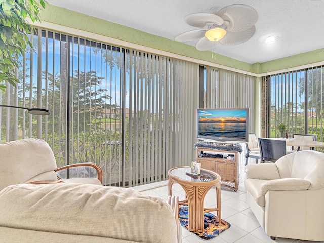 sunroom / solarium featuring ceiling fan