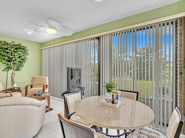 sunroom / solarium featuring ceiling fan