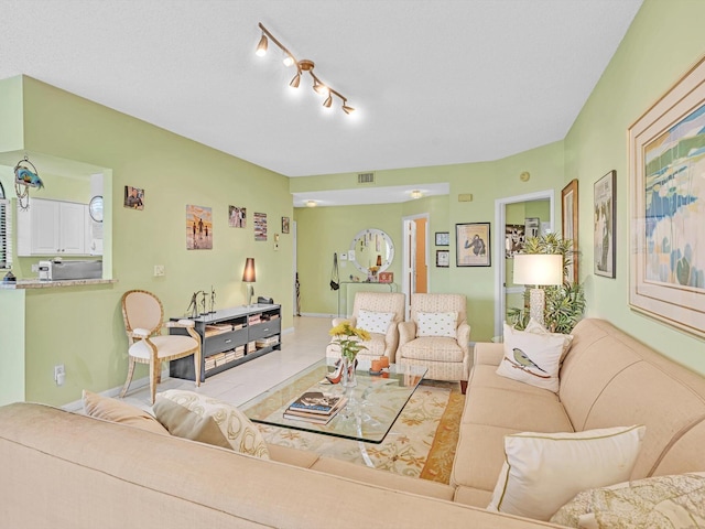 living room with light tile patterned floors and rail lighting