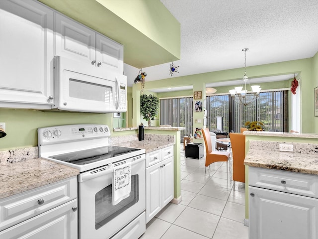 kitchen with decorative light fixtures, white appliances, white cabinets, and a notable chandelier