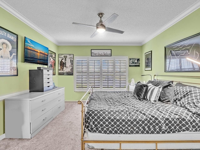 bedroom with ceiling fan, a textured ceiling, and ornamental molding