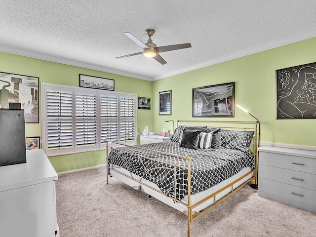 carpeted bedroom with ceiling fan, crown molding, and a textured ceiling