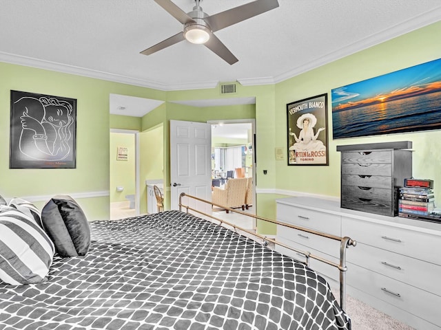 carpeted bedroom with a textured ceiling, ceiling fan, and ornamental molding