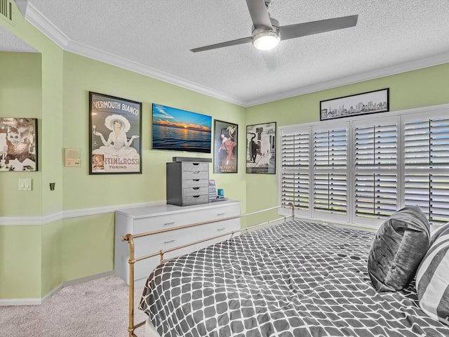 carpeted bedroom featuring ceiling fan, a textured ceiling, and ornamental molding