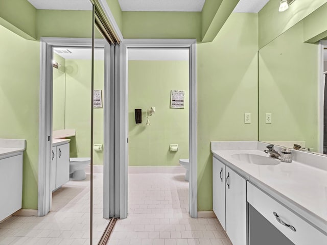 bathroom with toilet and vanity