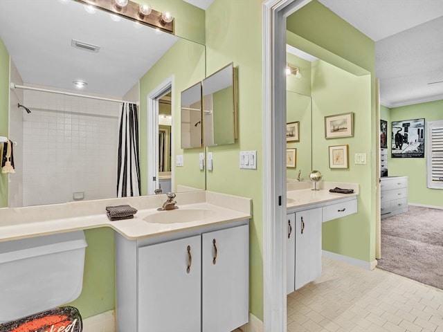 bathroom featuring curtained shower, a textured ceiling, vanity, and ornamental molding