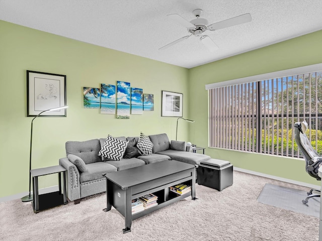 living room featuring light carpet, ceiling fan, and a textured ceiling