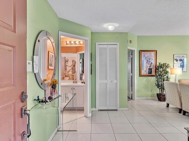 tiled foyer with a textured ceiling