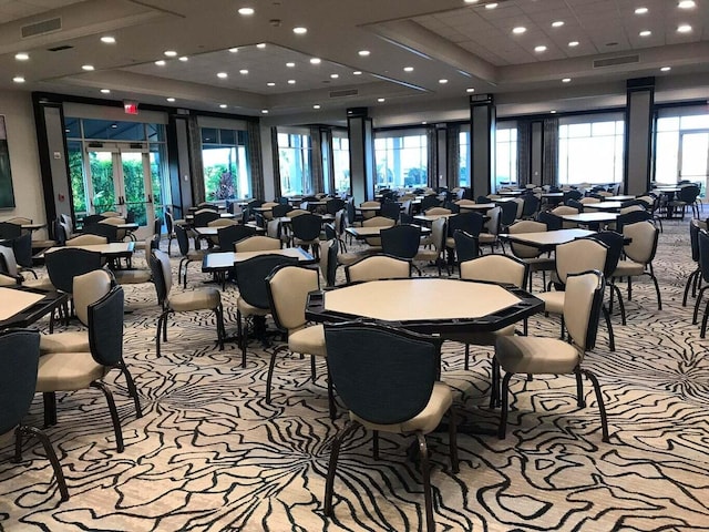 dining space featuring light carpet and a healthy amount of sunlight