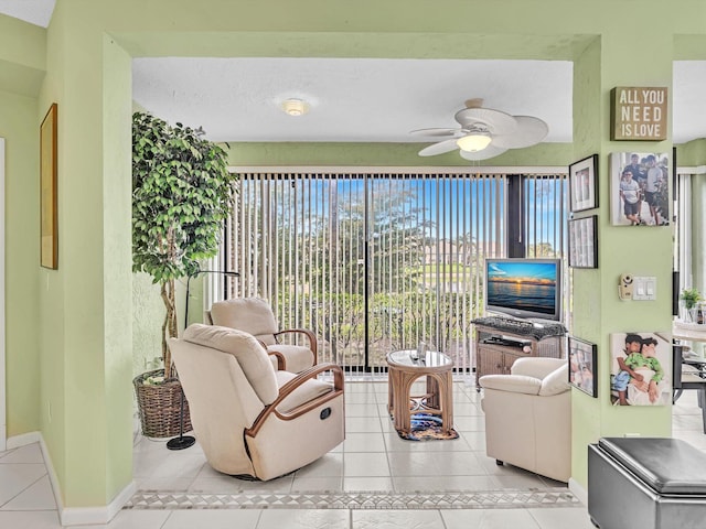 tiled living room featuring ceiling fan