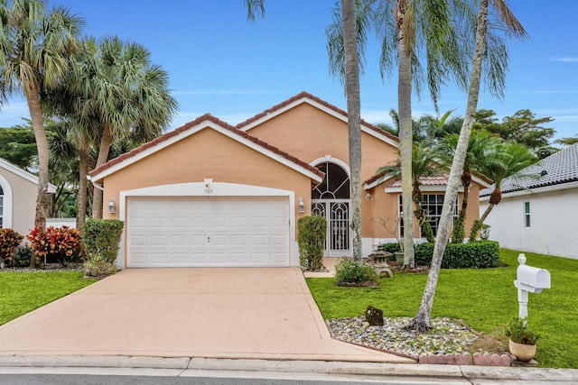 view of front of property featuring a front lawn and a garage