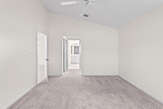 carpeted spare room with ceiling fan and high vaulted ceiling