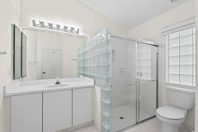 bathroom featuring a wealth of natural light, toilet, vanity, and an enclosed shower