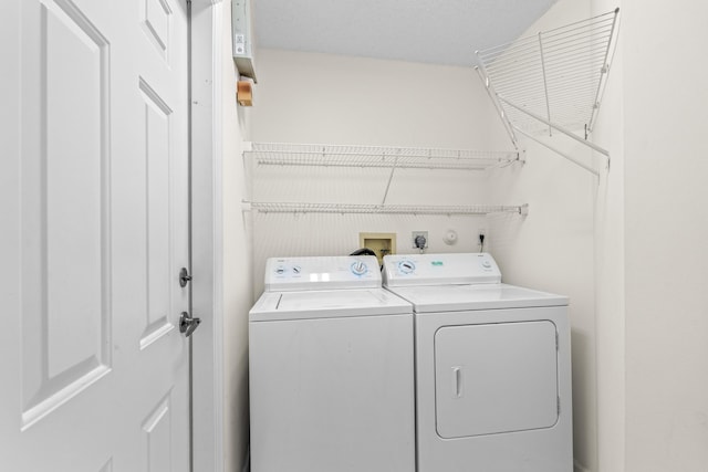 clothes washing area featuring washer and clothes dryer