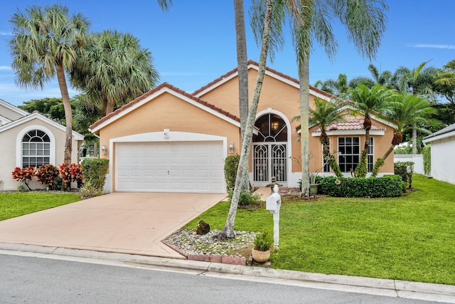 view of front of property with a garage and a front lawn