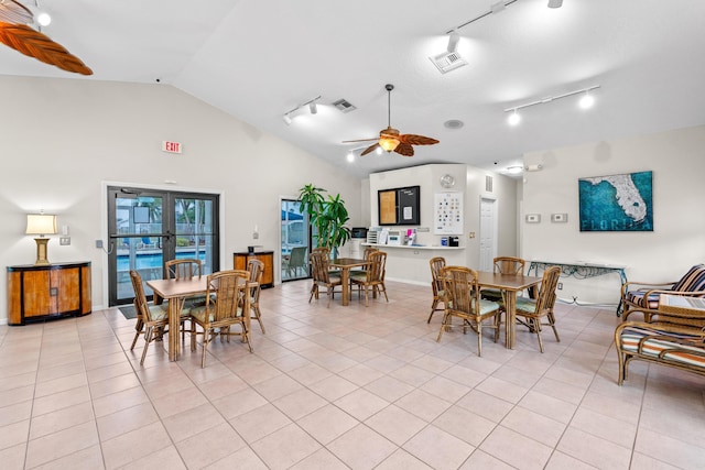 dining area with vaulted ceiling, ceiling fan, light tile patterned floors, and french doors