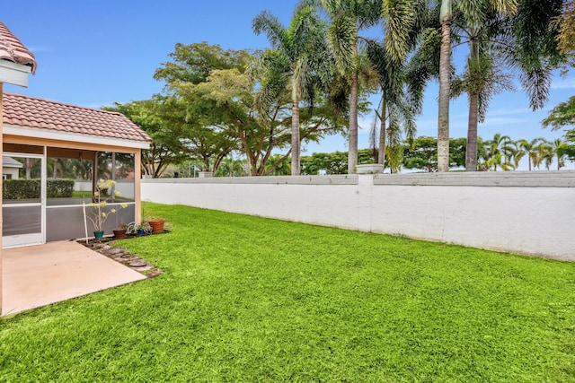 view of yard with a patio area and a sunroom