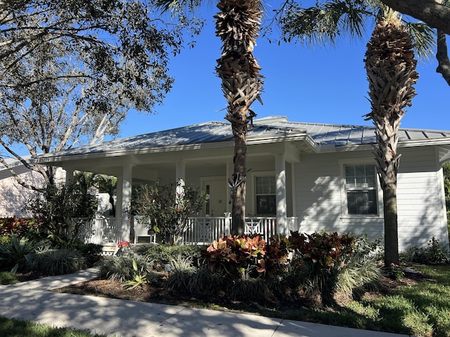 3289 Wymberly Dr, Jupiter, FL 33458 - view of front of house with a porch and metal roof