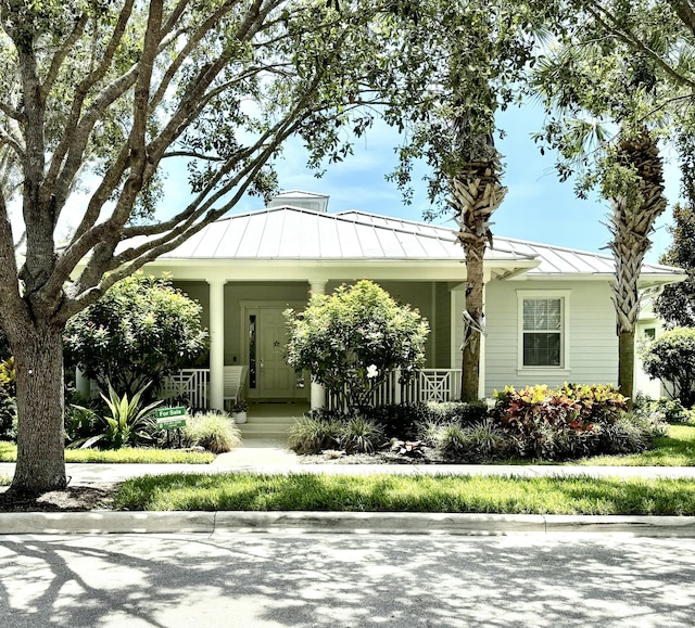 3289 Wymberly Dr, Jupiter, FL 33458 - view of front of property with a standing seam roof, covered porch, and a metal roof
