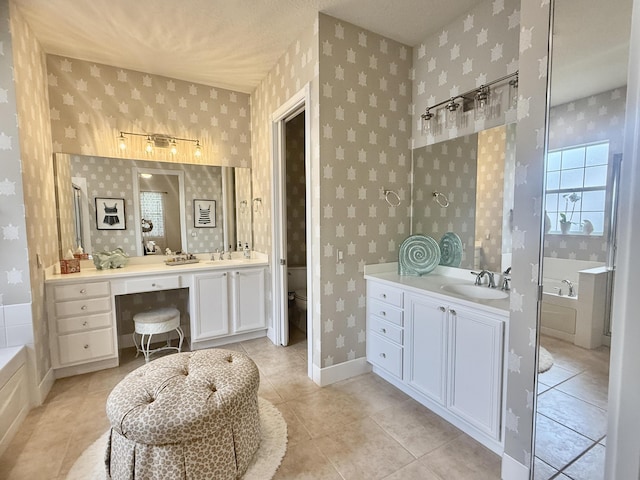 3289 Wymberly Dr, Jupiter, FL 33458 - full bathroom featuring wallpapered walls, two vanities, tile patterned flooring, and a bathtub