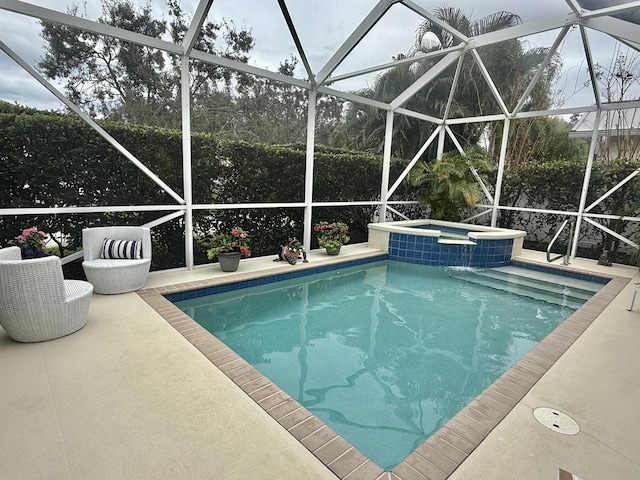 view of pool featuring a patio, a lanai, and a pool with connected hot tub