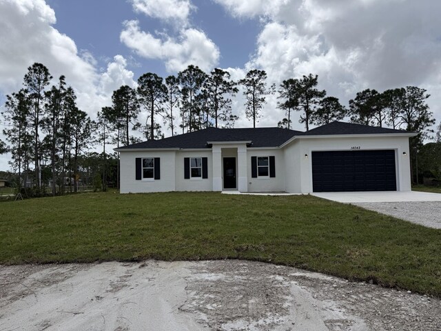 14042 82nd St N, The Acreage, FL 33470 - view of front of house featuring concrete driveway, a garage, a front lawn, and stucco siding
