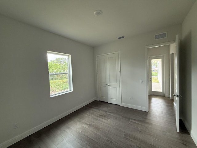 14042 82nd St N, The Acreage, FL 33470 - unfurnished bedroom with baseboards, dark wood-style flooring, and a closet