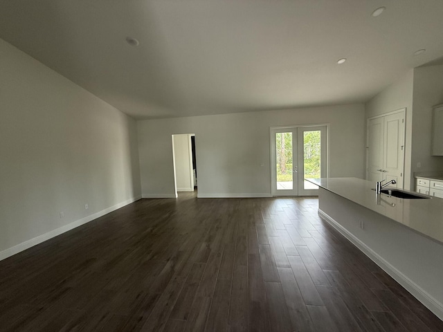 14042 82nd St N, The Acreage, FL 33470 - unfurnished living room featuring a sink, dark wood-style flooring, baseboards, recessed lighting, and french doors