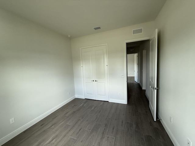 14042 82nd St N, The Acreage, FL 33470 - unfurnished bedroom featuring dark wood-style floors, baseboards, and a closet