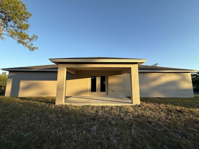 rear view of property with a patio area and a yard