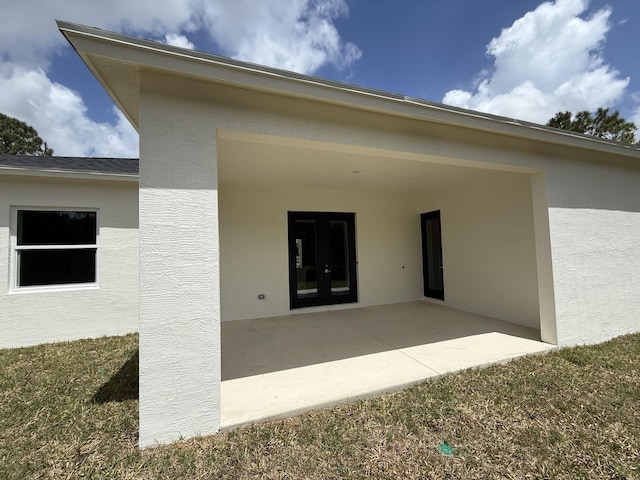 14042 82nd St N, The Acreage, FL 33470 - property entrance with a patio area, stucco siding, and french doors
