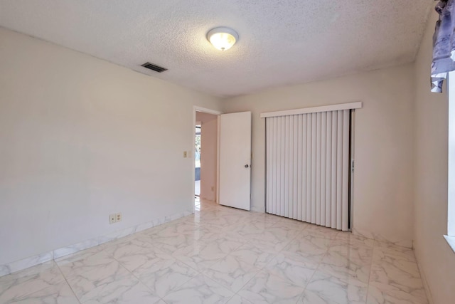 empty room with a textured ceiling