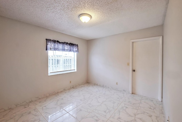 spare room featuring a textured ceiling