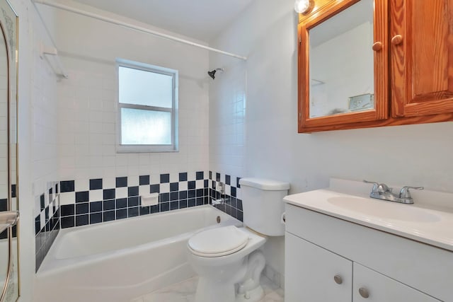 full bathroom featuring toilet, vanity, and tiled shower / bath combo