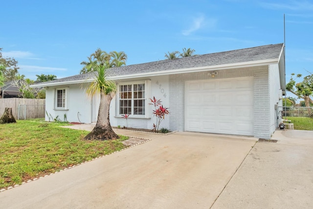 single story home featuring a front yard and a garage